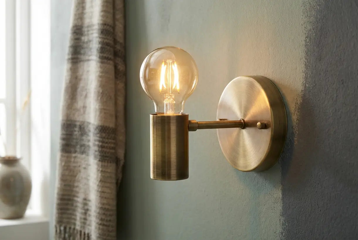 Modern battery powered wall sconce with gold finish and warm LED glow, close-up detail showing craftsmanship