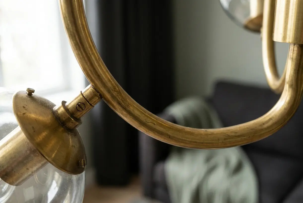 Detailopname van de messing armen en glazen bollen van een mid-century kroonluchter