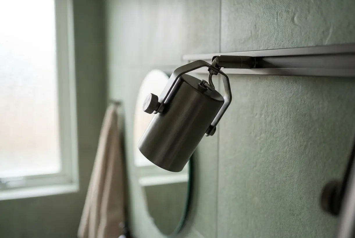 Modern track lighting head with directional adjustment mechanism for bathroom fixtures