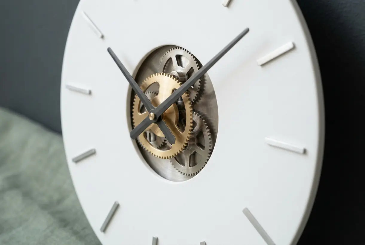 Close-up detail of modern wall clock hands and dial showcasing sleek contemporary design