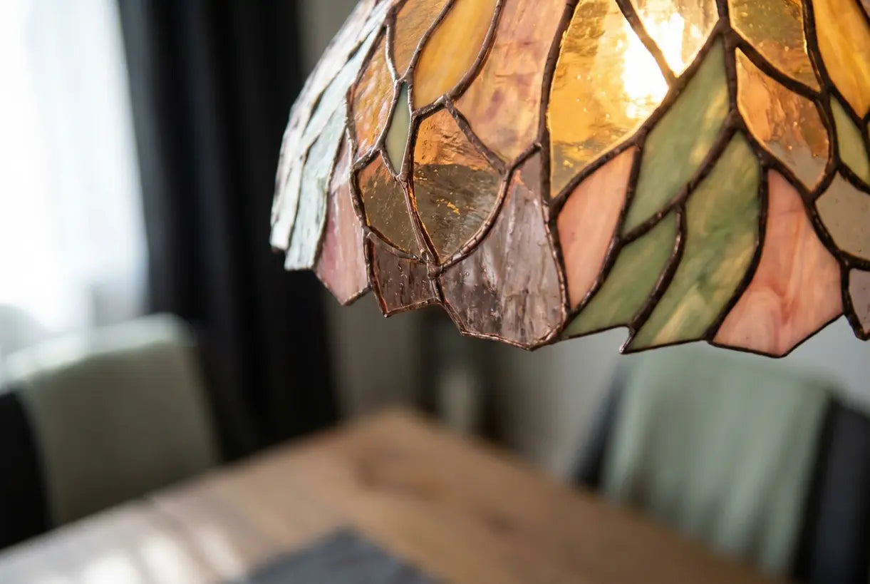 Close-up of handcrafted Tiffany style stained glass chandelier panels with amber and rose colored glass